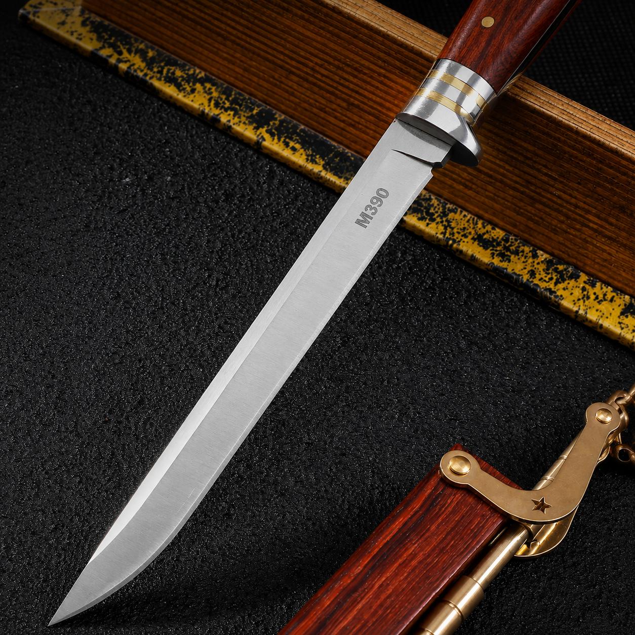 A close-up of a folding knife featuring an M390 steel blade, a wood handle, and silver and brass metal guards, displayed on a dark textured surface.