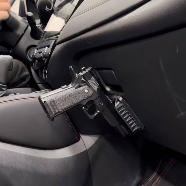 Quick draw magnetic pistol holster for secure and fast handgun access.