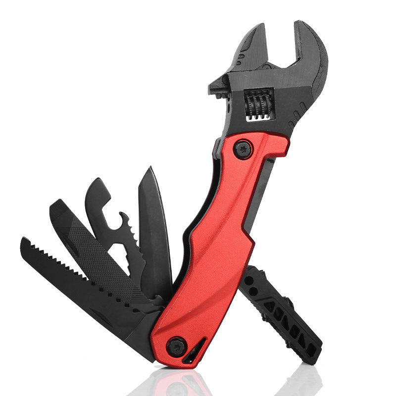 A red-handled folding adjustable wrench multi-tool with several black tools deployed, including a saw blade, file, bottle opener, and knife, displayed on a white background.