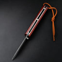 A closed EDC folding knife with a polished red wood handle and a slender blade profile, featuring a brown leather lanyard and silver liners, displayed on a dark textured background.
