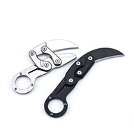 Two open mechanical folding karambit knives, one silver and one black, featuring finger ring handles and articulated arms with visible star screws, displayed on a white background.