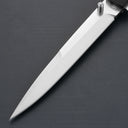 A close-up of a sharp silver stainless steel folding knife blade with a cylindrical thumb stud, displayed on a dark grey surface.