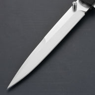 A close-up of a sharp silver stainless steel folding knife blade with a cylindrical thumb stud, displayed on a dark grey surface.
