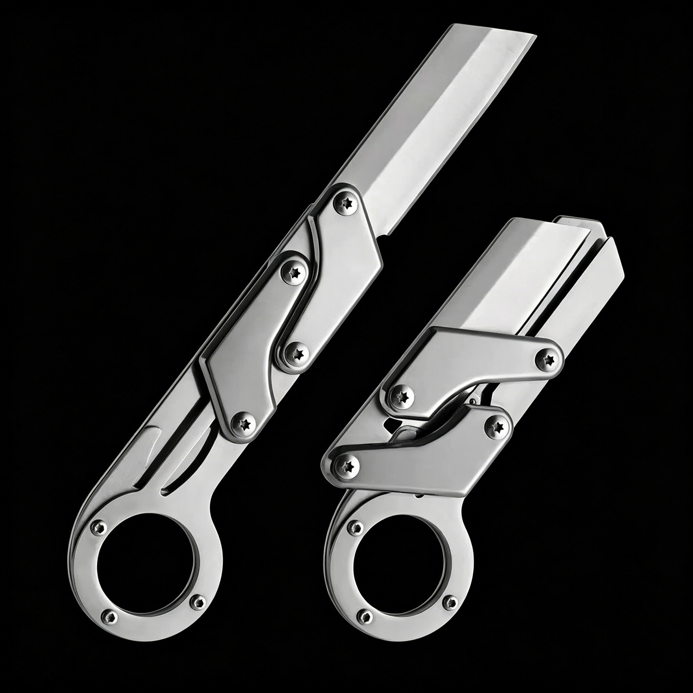 Two silver folding knives with a ring handle, mechanical linkage design, and a grooved blade, shown open and closed on a black background.