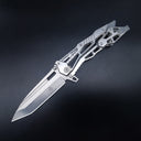 An open tactical folding knife with a silver Tanto blade and a skeletonized metal handle, displayed on a dark background.