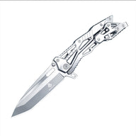 An open tactical folding knife with a silver Tanto blade and a skeletonized metal handle, displayed on a white background.