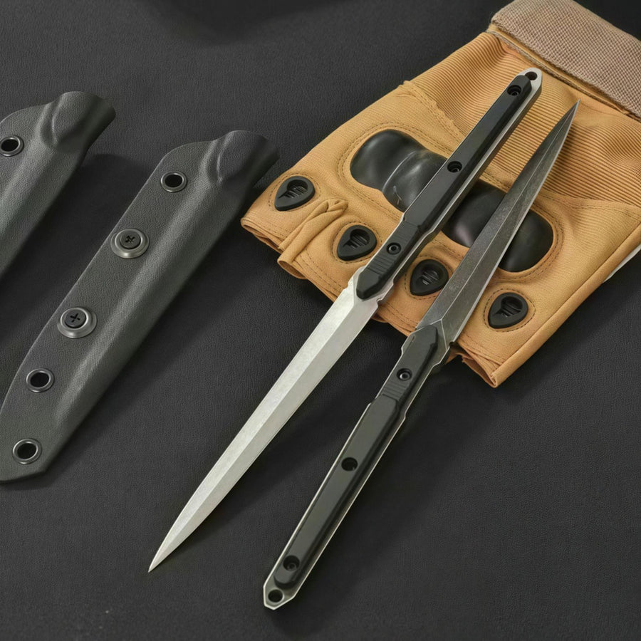 Two open slim tactical folding knives, one with a silver blade and one with a black blade, displayed next to tan tactical gloves and black sheaths on a dark background.