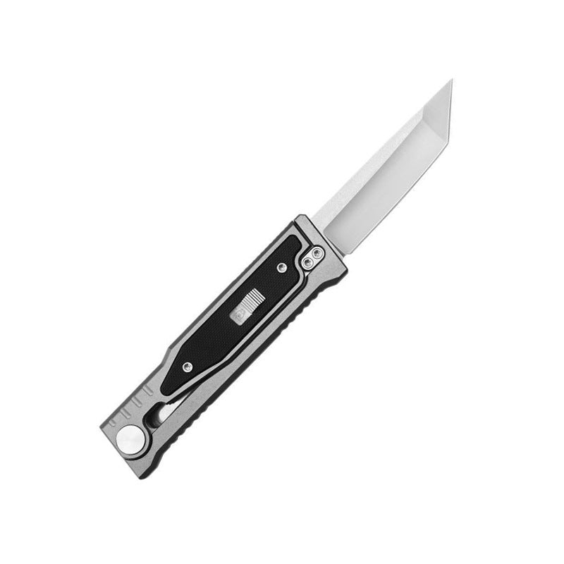 An open tactical folding knife with a grey handle and black insert, displayed on a white background.