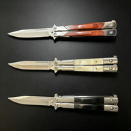 Three open balisong butterfly knives with silver blades and different handle materials: wood, pearl, and black, displayed horizontally on a dark background.