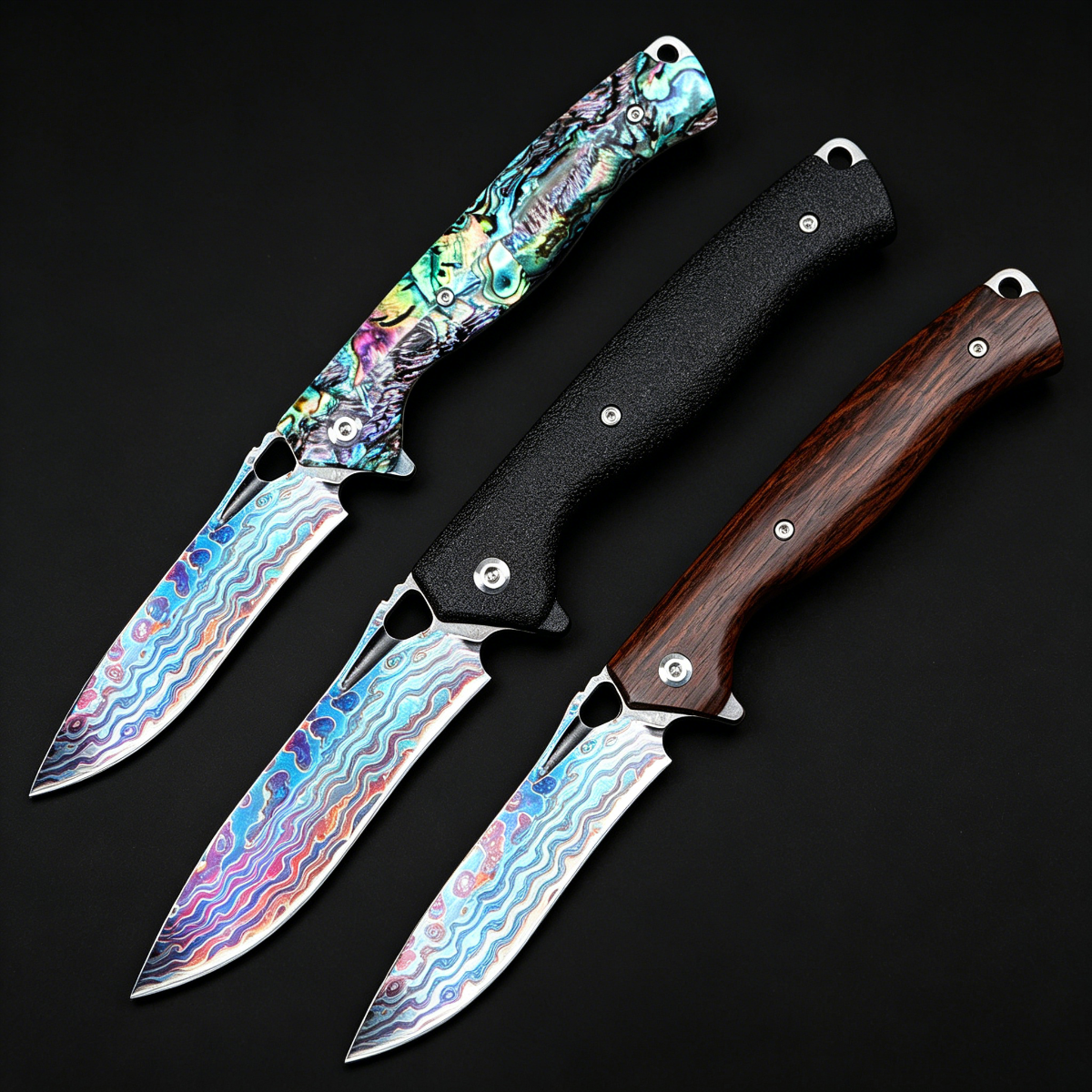 Three different EDC folding knives displayed on a black background, featuring colorful Damascus/Titanium patterned blades and handles in shell, matte black, and dark wood finishes.