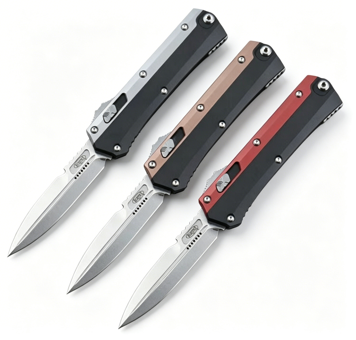 Three open out-the-front folding knives with black, bronze, and red handles and silver blades, displayed on a white background.