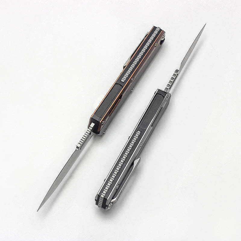 Two open out-the-front knives with slim blades, one with a grey handle and one with a bronze handle, displayed on a white background.