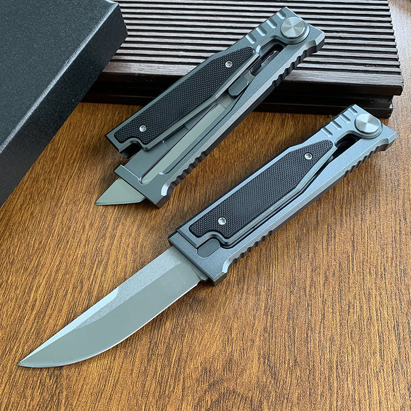 Two tactical folding knives, one partially open and one closed, displayed on a wooden background.