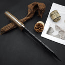 Close-up of a knife's wooden handle and serrated spine, displayed on a dark surface with pine cones, hemp rope, and decorative wood.